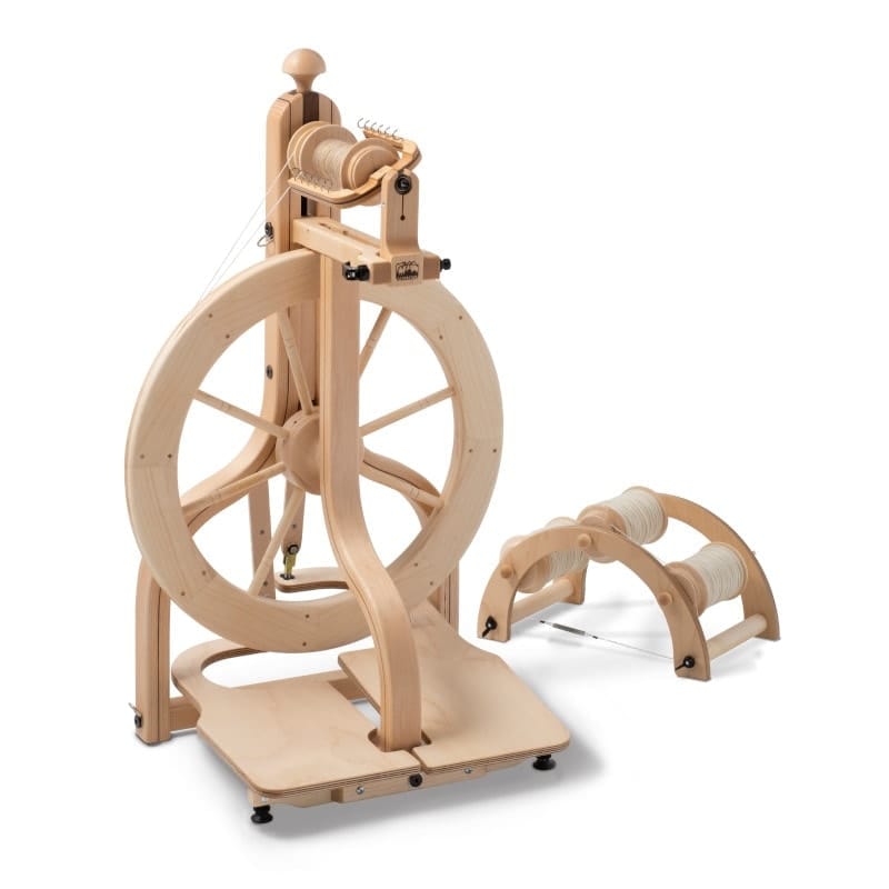 Two antique wooden spinning wheels, also called knitting yarn